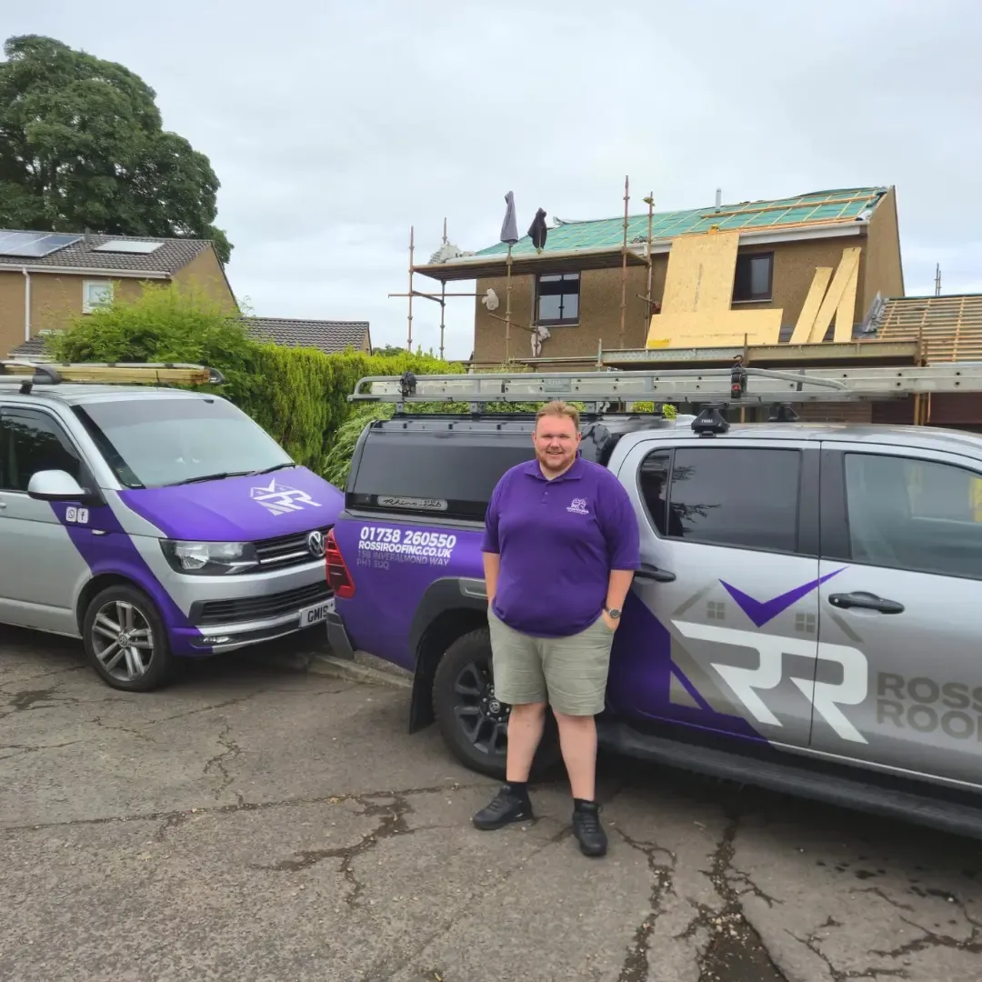 The Rossi Roofing team and branded vans on-site in Perth, Tayside — full re-roof in progress in the background