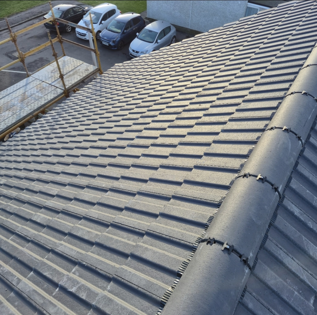Newly completed concrete tile pitched roof with mechanically fixed ridge — Rossi Roofing project